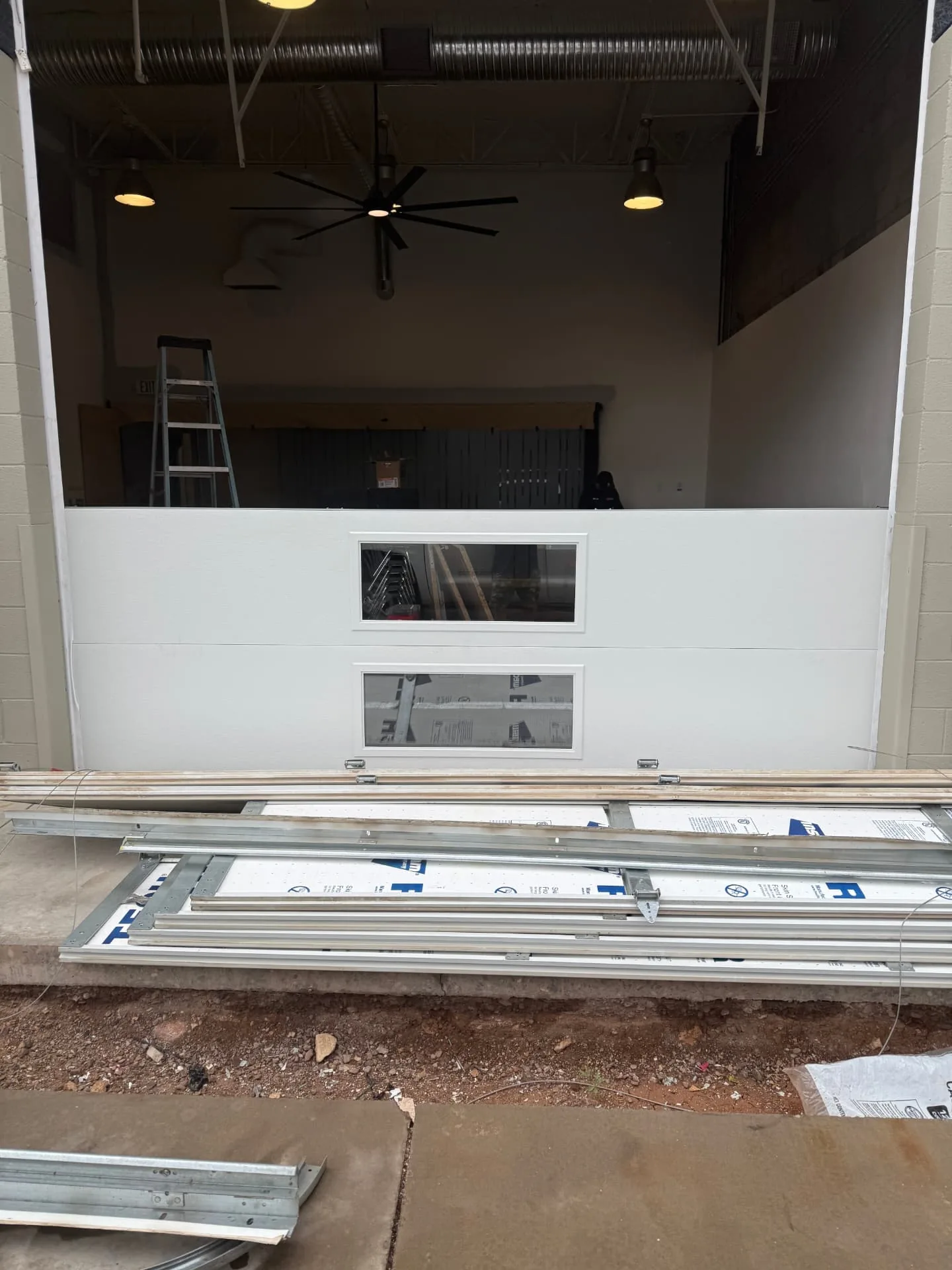 Technician replacing a broken garage door torsion spring at an Anthem, AZ home