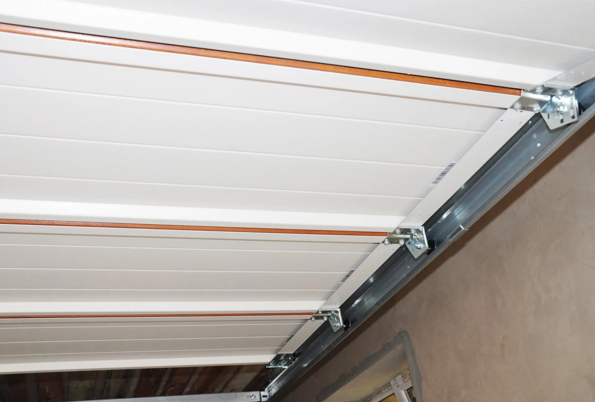 Overhead garage door track and opener rail inside a New River, AZ garage